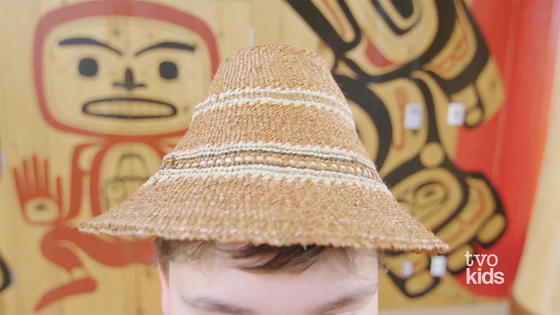 Drakon is wearing a cedar bark hat as part of the traditional regalia of the Tsimshian nation.