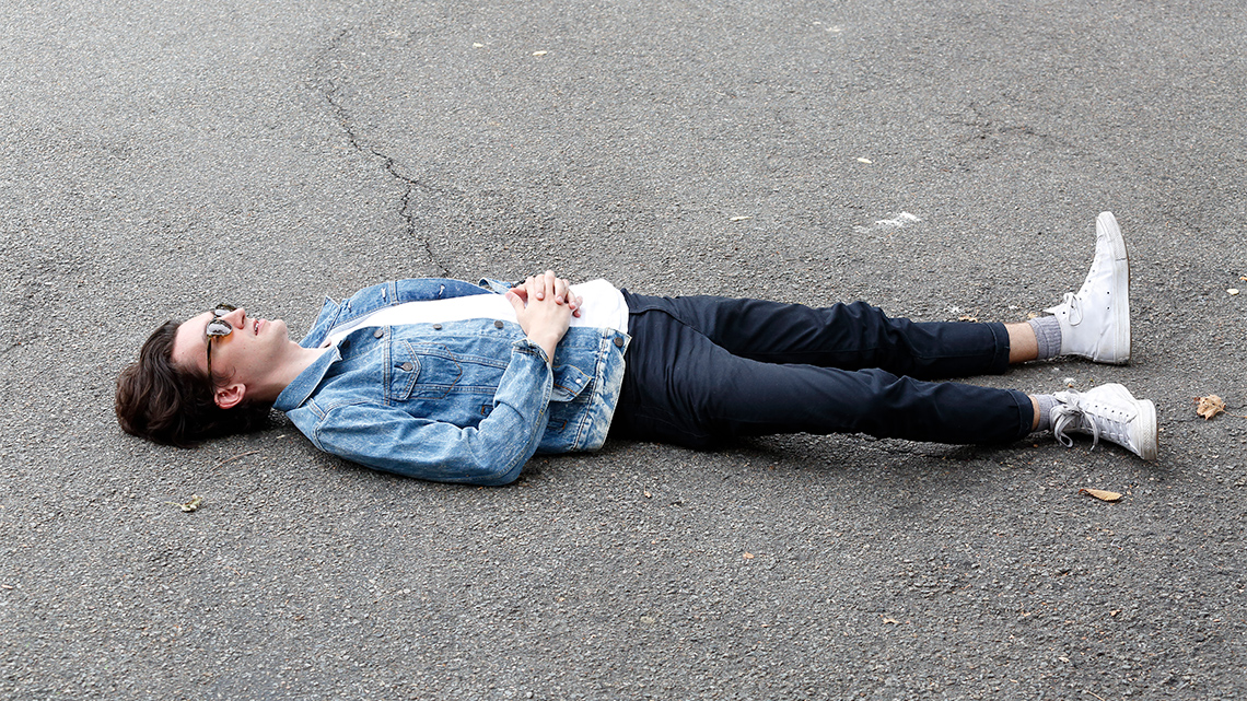 A person is lying on the floor on their back.