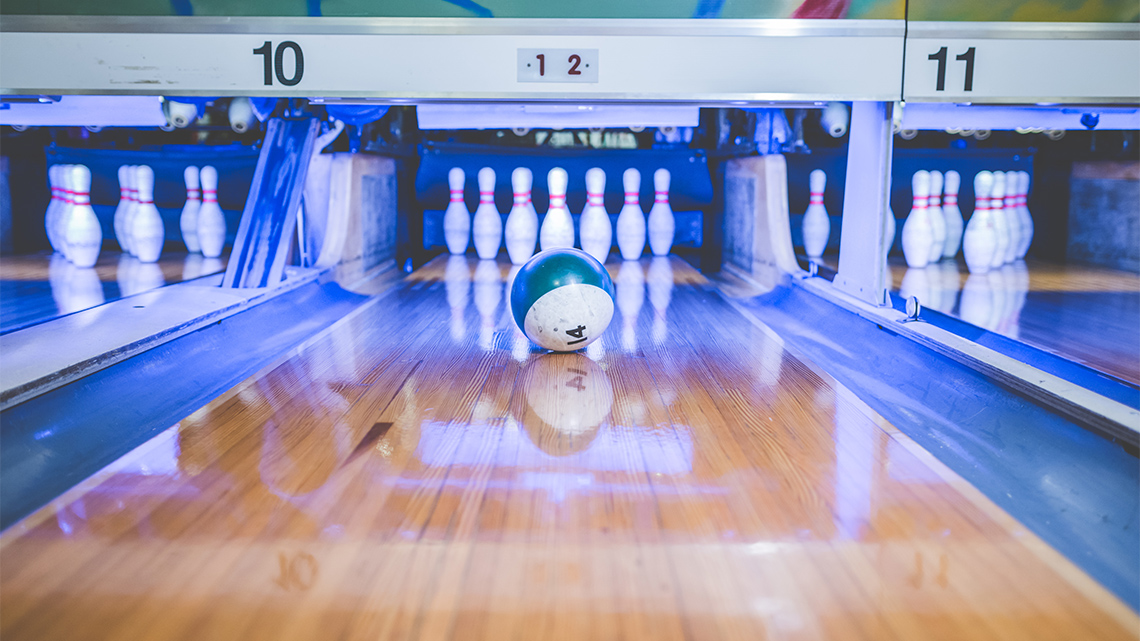 A bowling ball is rolling on the floor.