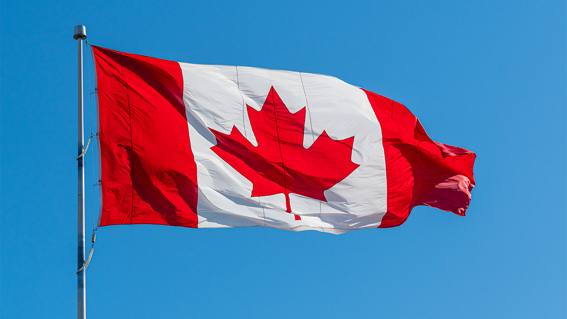 The Canadian flag is waving in the wind.