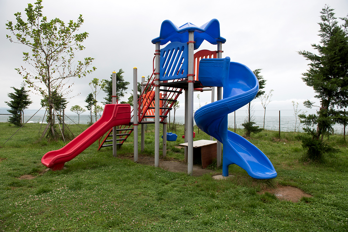 A twisted slide and a straight slide on a playground