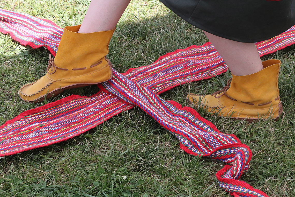 A dancer is performing a Sash dance by making steps on a strip of cloth called Sash.