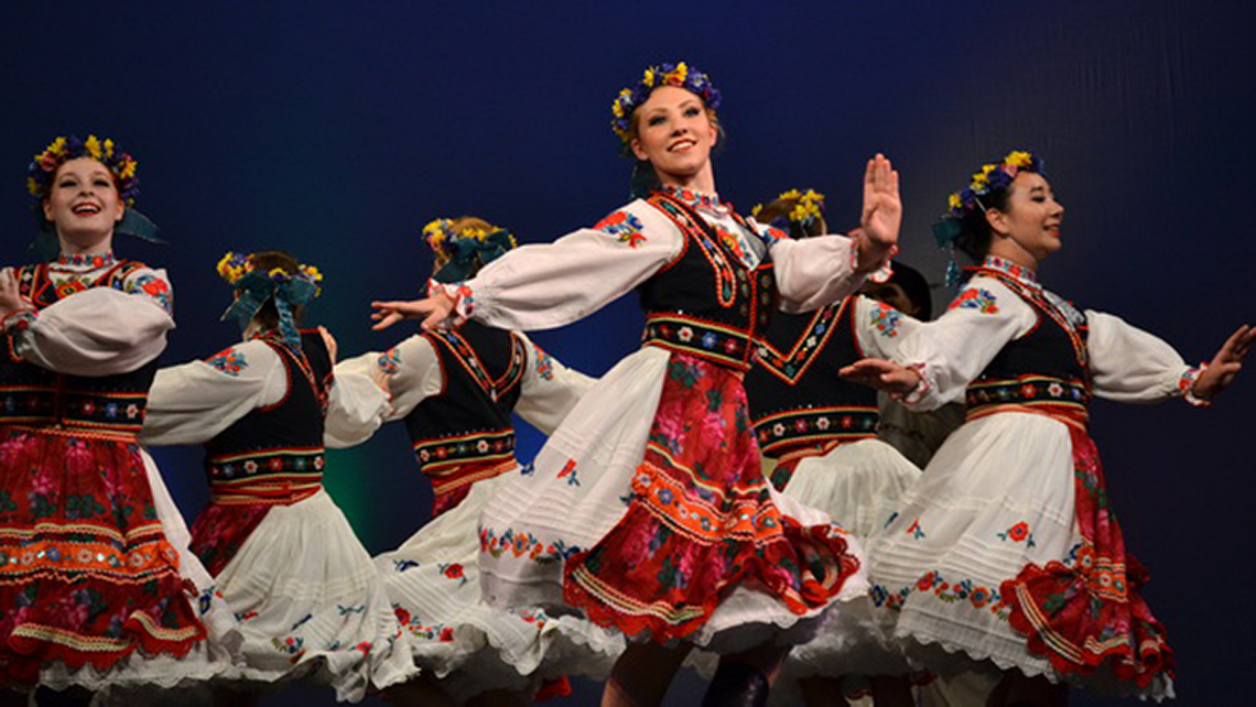 Group of Ukrainian dancers in their colourful outfits and floral headdresses.