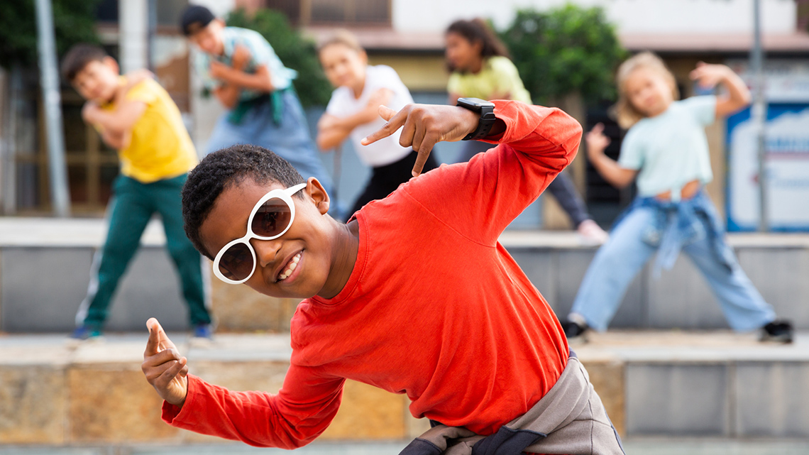 Children dancing and moving their arms.