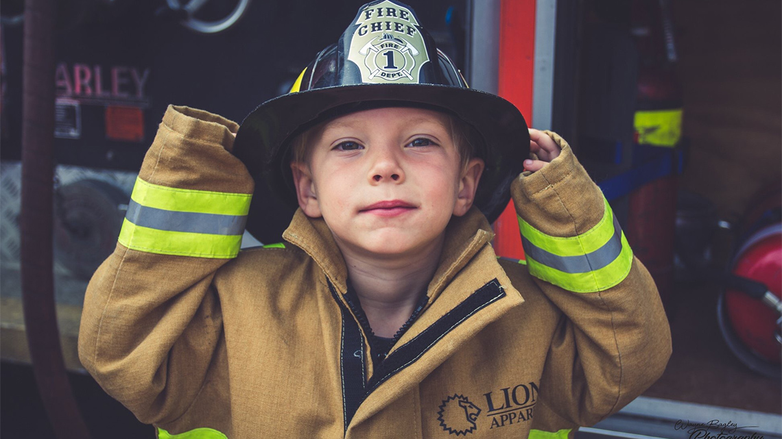 Child dressed as a firefighter.