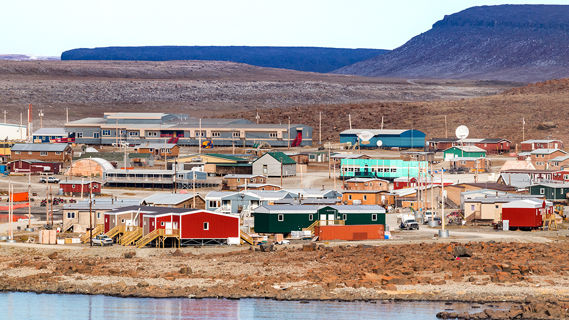 A coastal town with small colourful buildings found in the Inuvialuit territory.