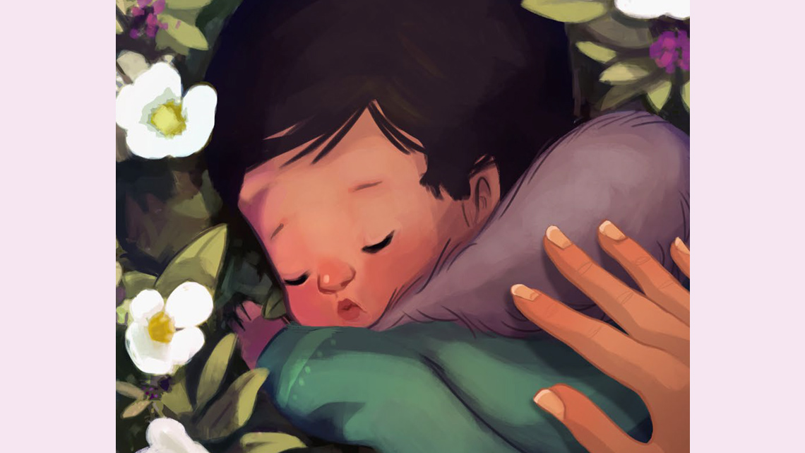 A baby sleeps on the flowers while an adult's hand is on their back.