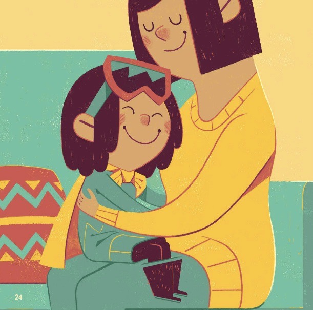 A little girl sits on the lap of an adult. She is hugging the adult and smiling.
