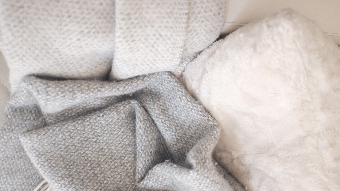 There is a pile of cozy blankets
