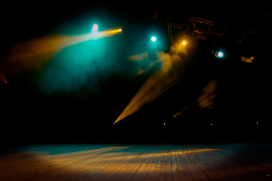 Lights shining down onto a stage.