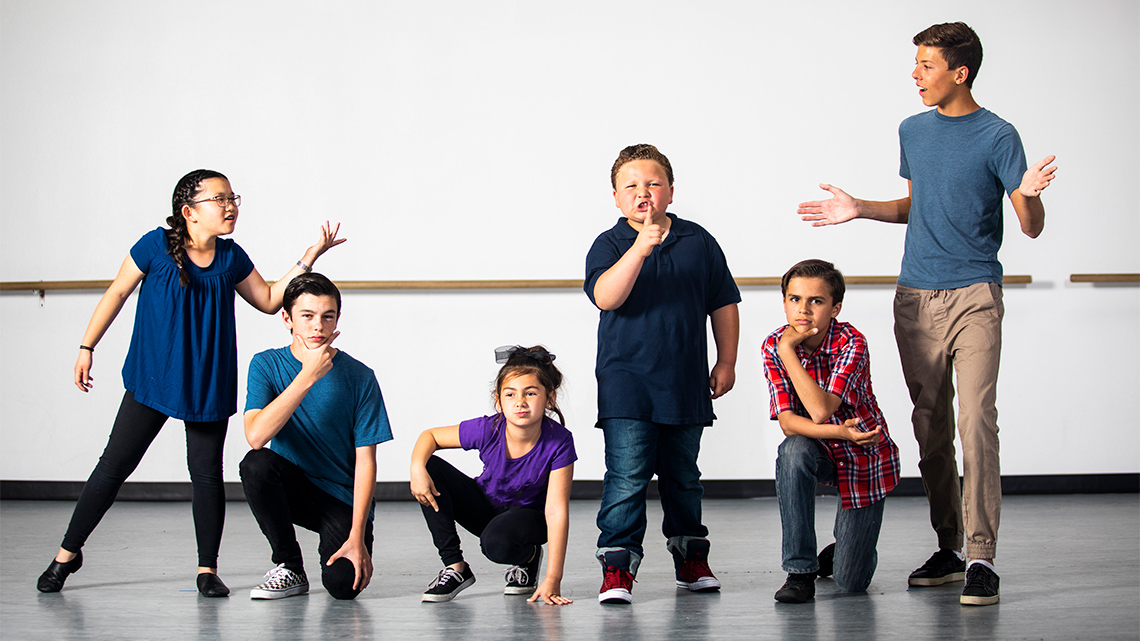 A group of children making various poses and expressions. 