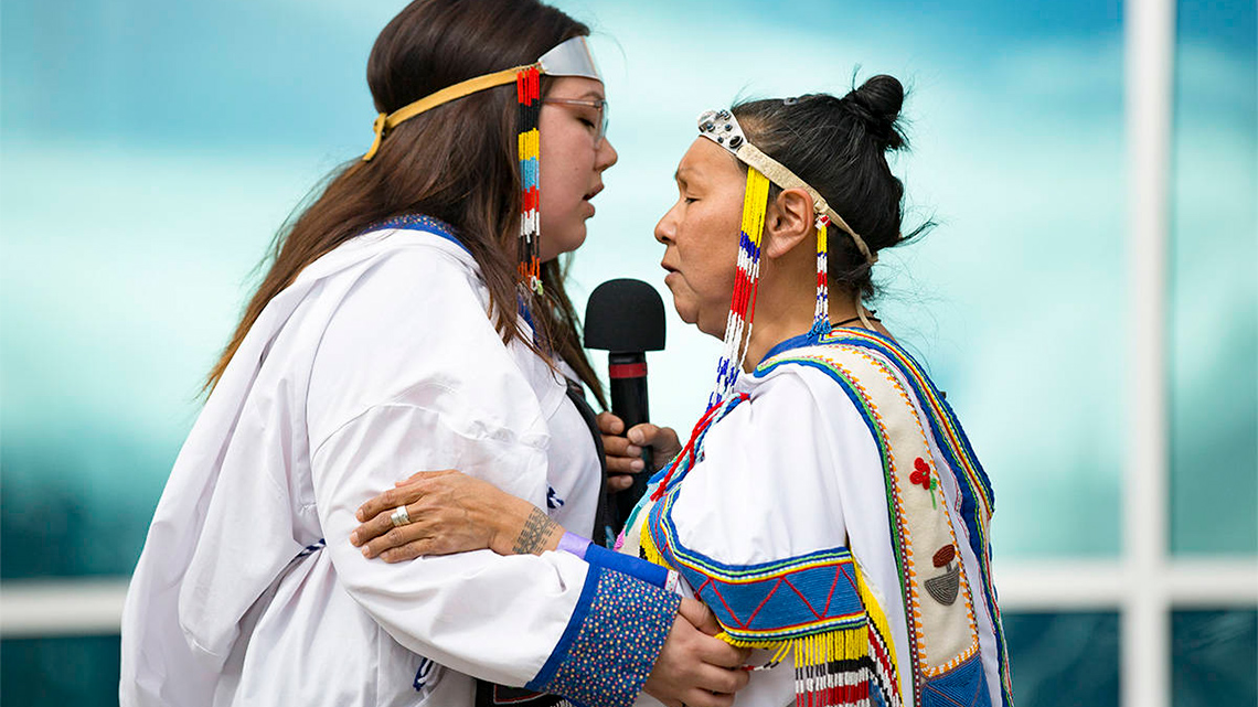 Two Inuit throat singing directly in front of each other. 