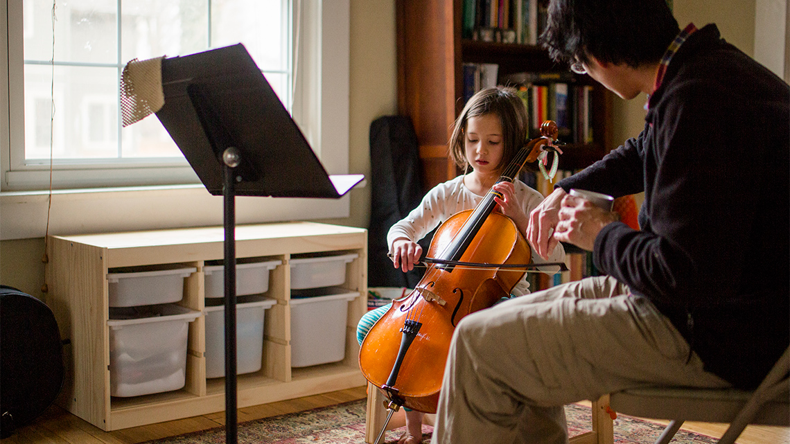 A child being taught how to play an instrument.