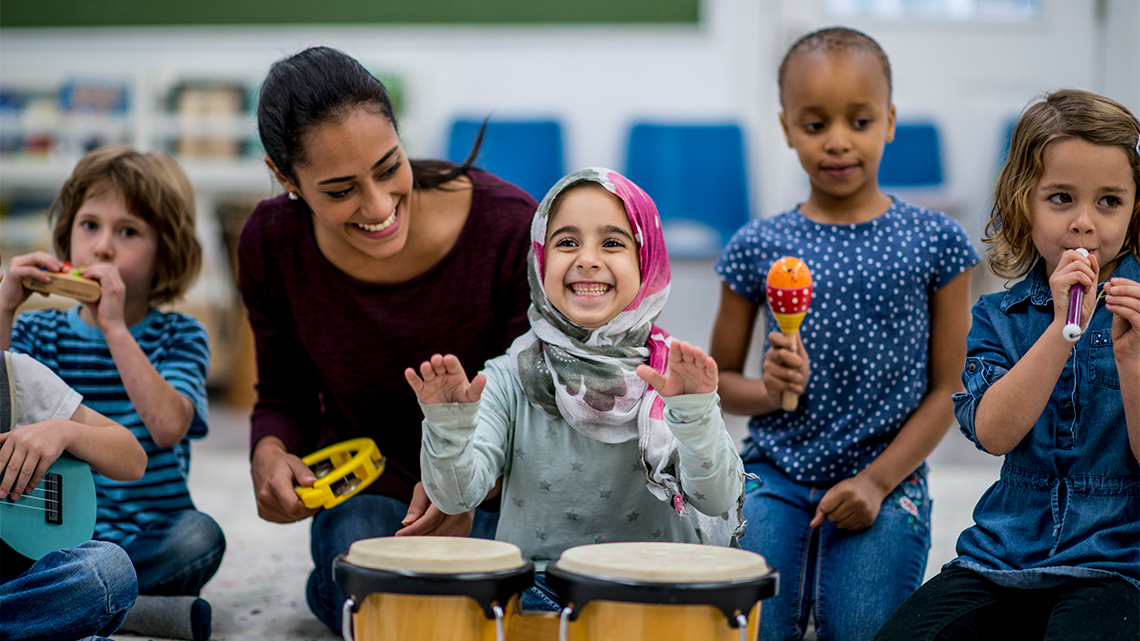 Children playing a variety of instruments in a music class.