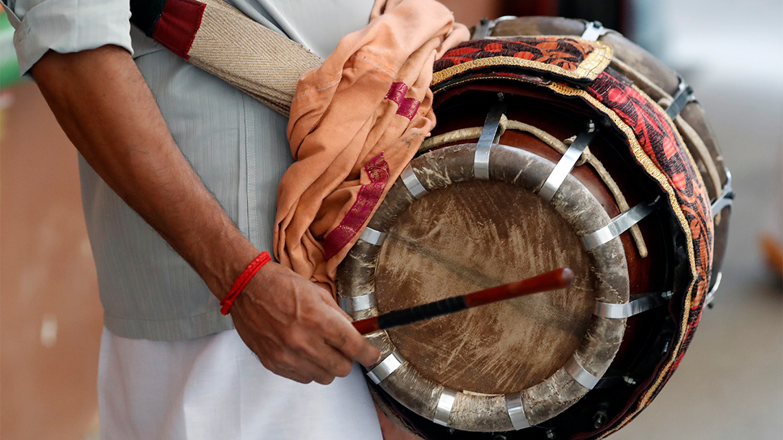 A musician playing a thavil.