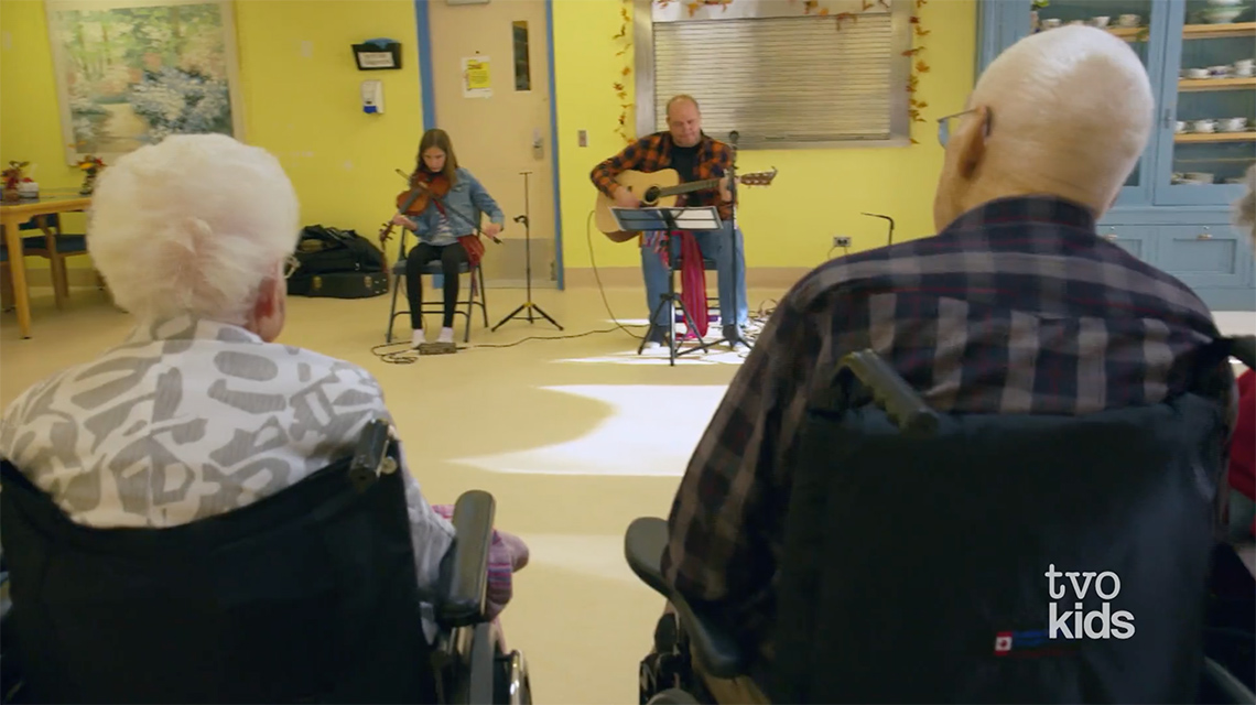 Morgan and her dad playing for the elders in her community.