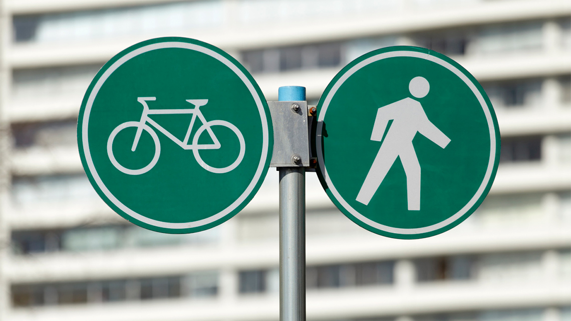 Symbols for a person and a bicycle.