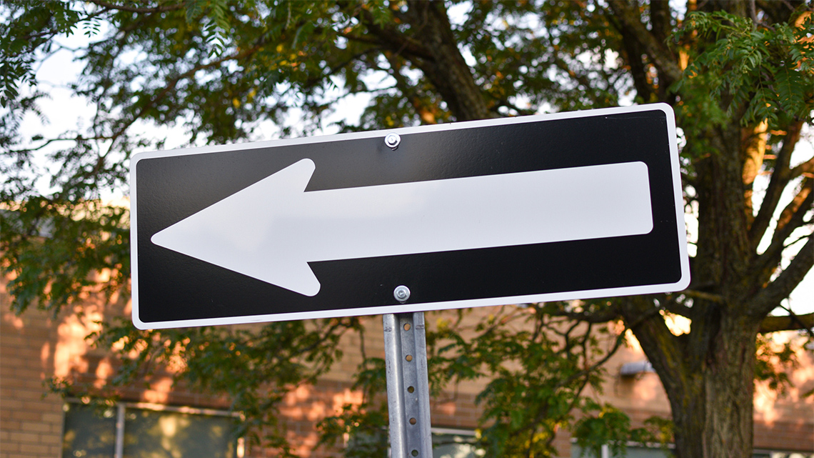 A one way sign, which is an arrow pointing the right way to go.