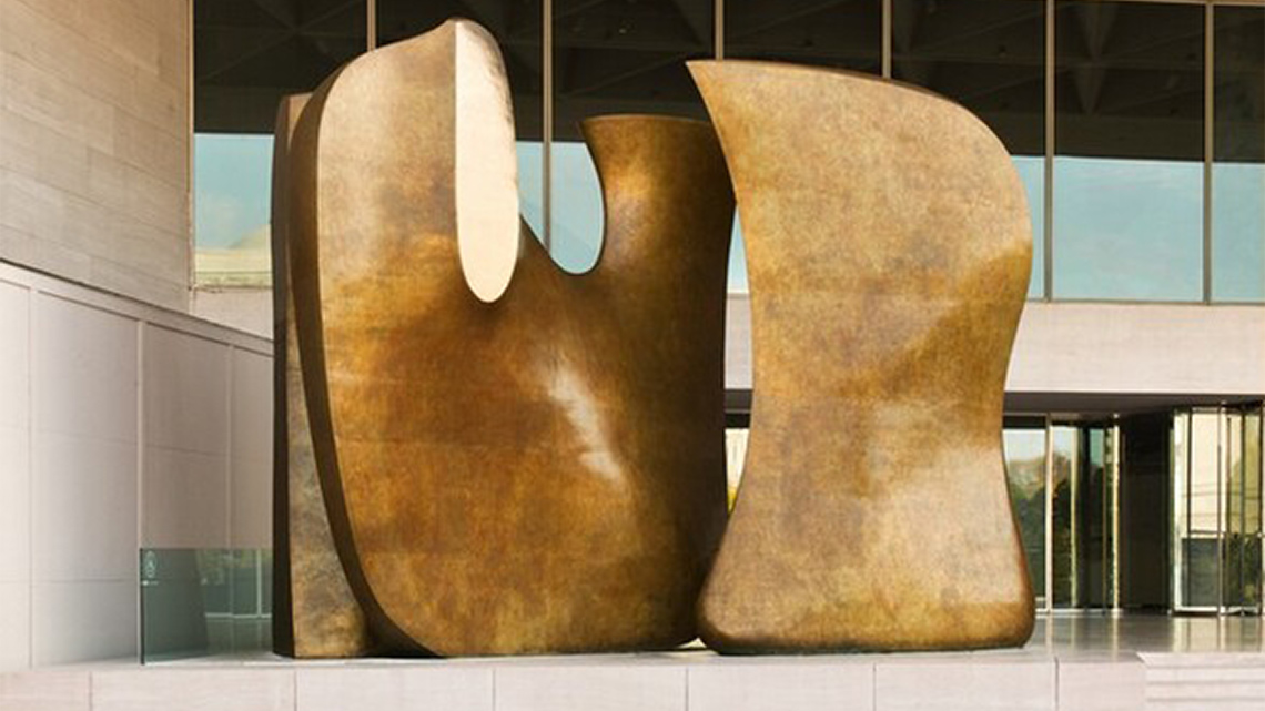 A sculpture with two abstract organic shapes. The sculpture is big enough you can move between it.