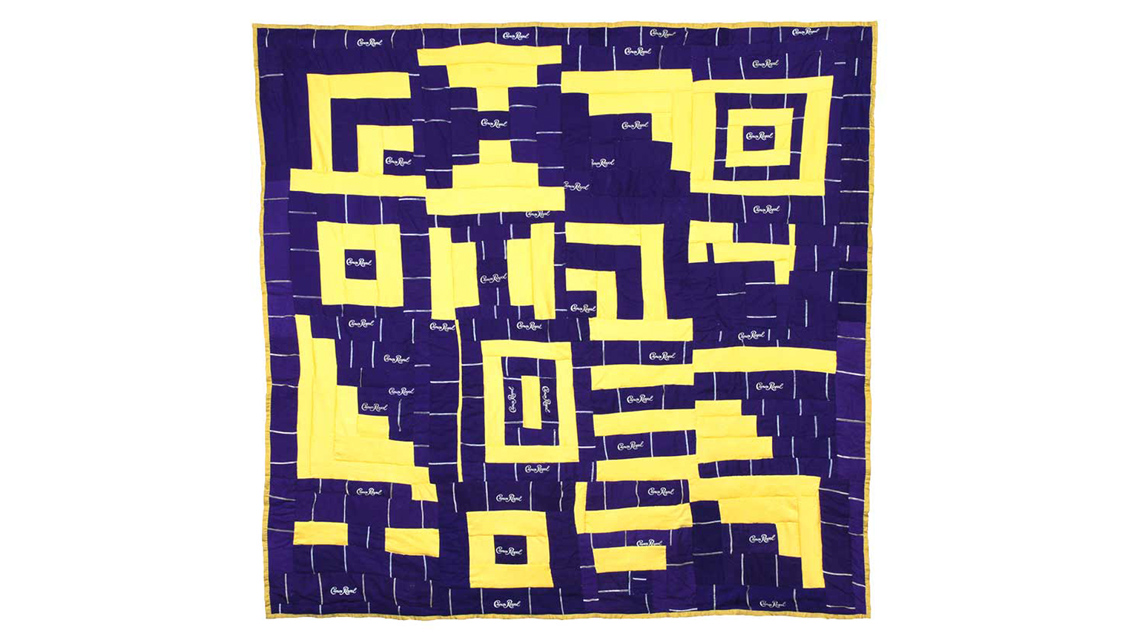 A vibrant quilt with a pattern of geometric stairs and rectangles.