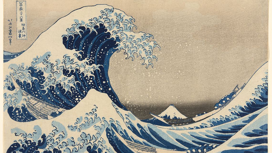 An image of a big wave. The wave is much bigger than the small mountain in the background.