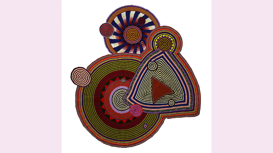 An image of big geometric circles and a triangle made with crocheted yarn and plastic beads.