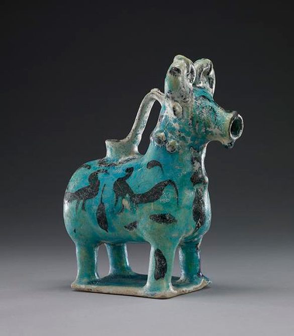 An image of a pitcher made from pottery and shaped like a bull. It could hold water inside.