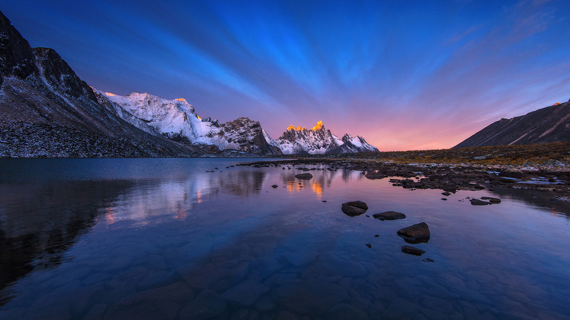 Morning sunrise over a mountain lake landscape.