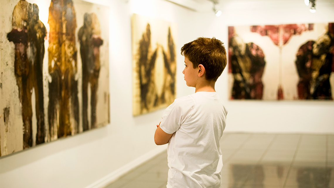 Student looking at a painting in a museum