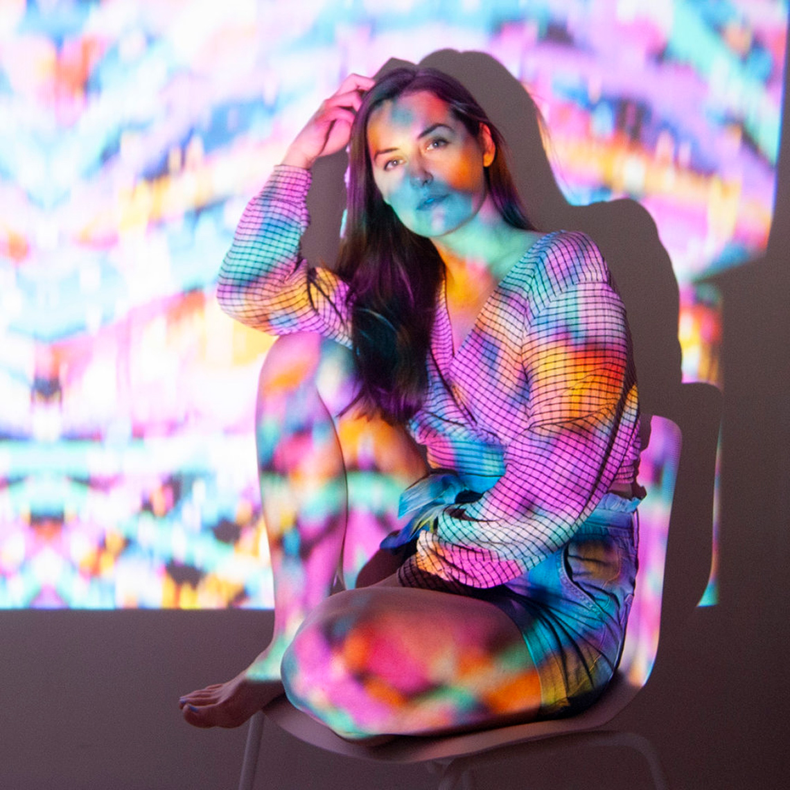Brianne Burnell seated on a chair.