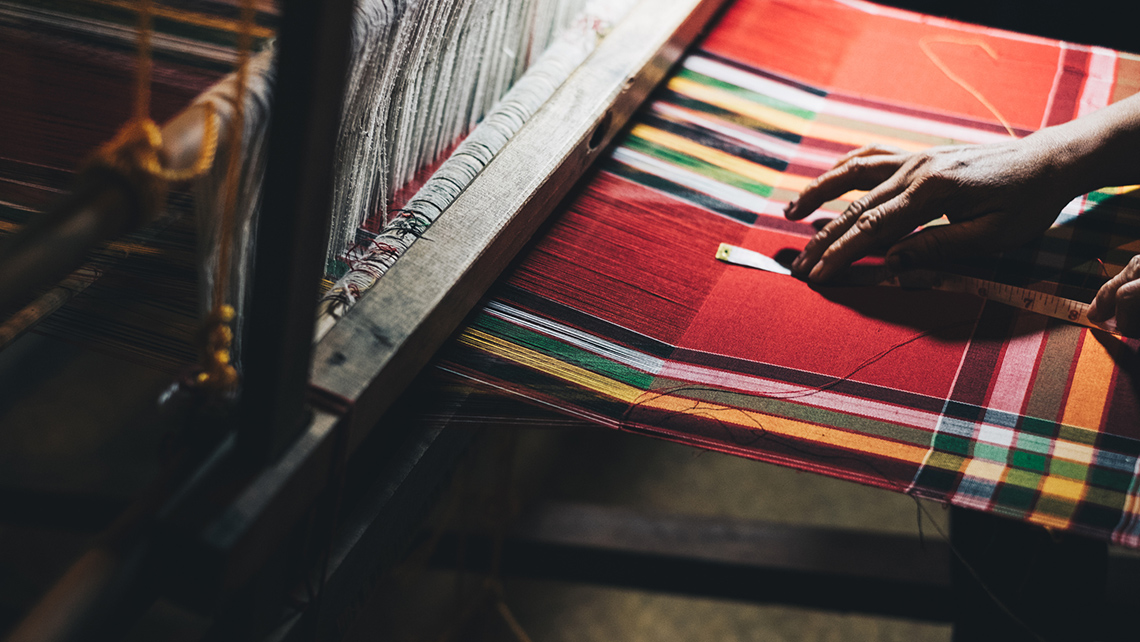 A person working on a loom