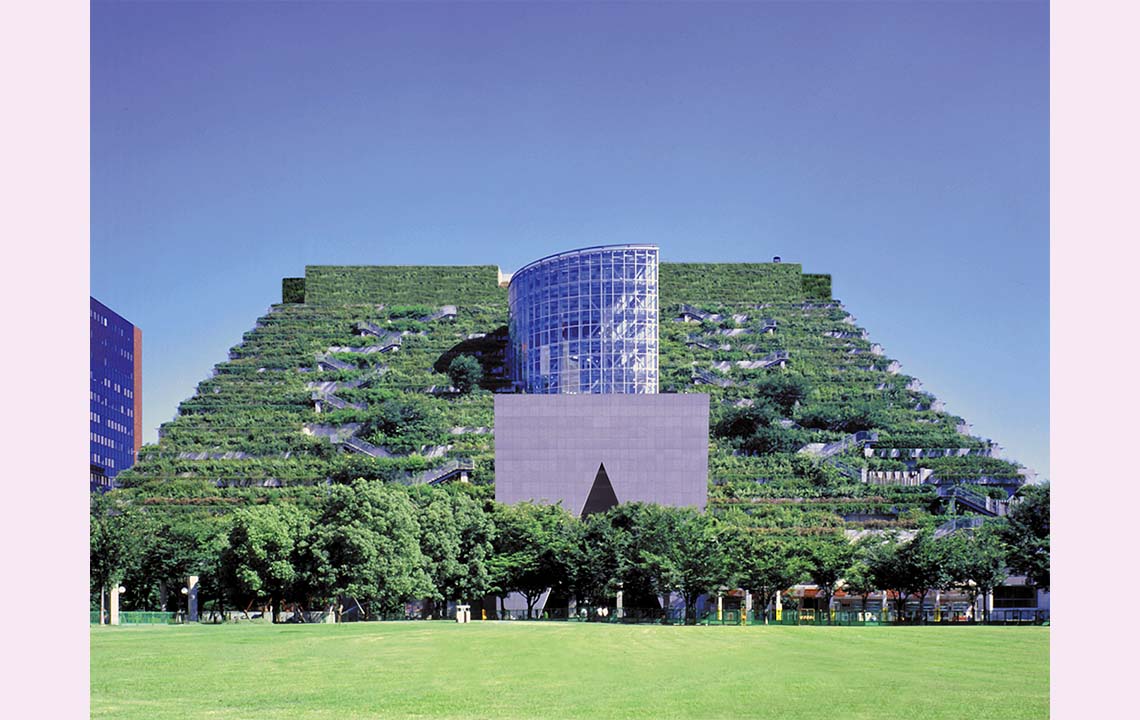 A building with lush gardens terraces, giving the impression that the building is covered in greenery.