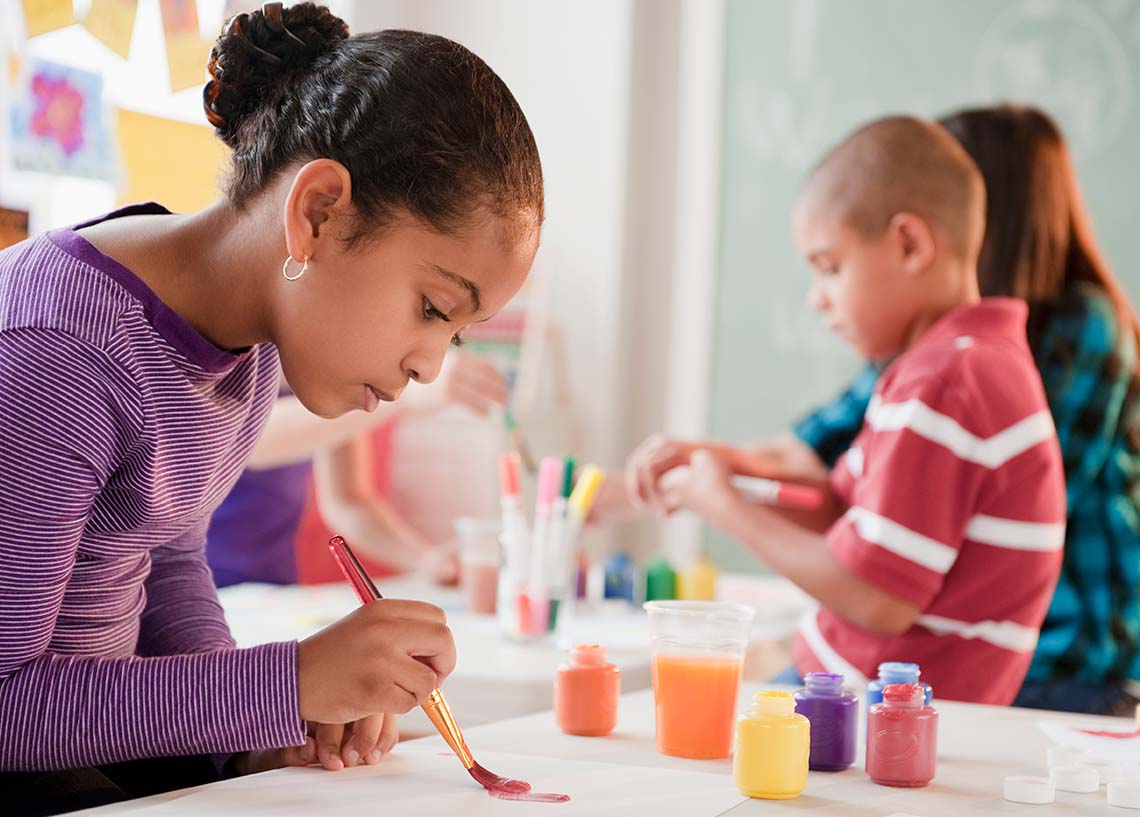 Students painting in a visual arts class.