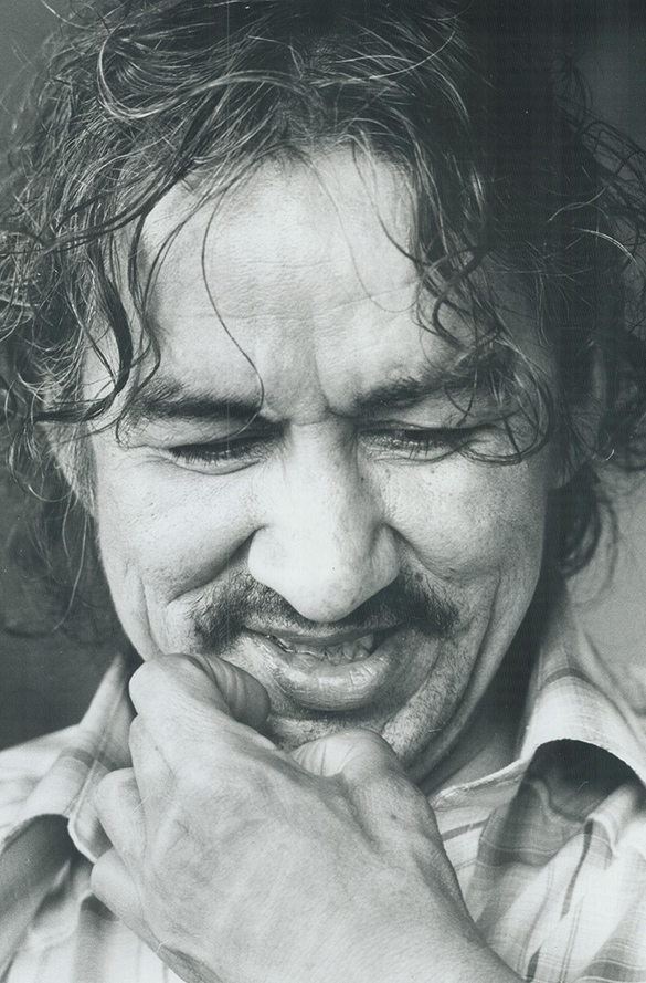 A black and white portrait of Norval Morrisseau