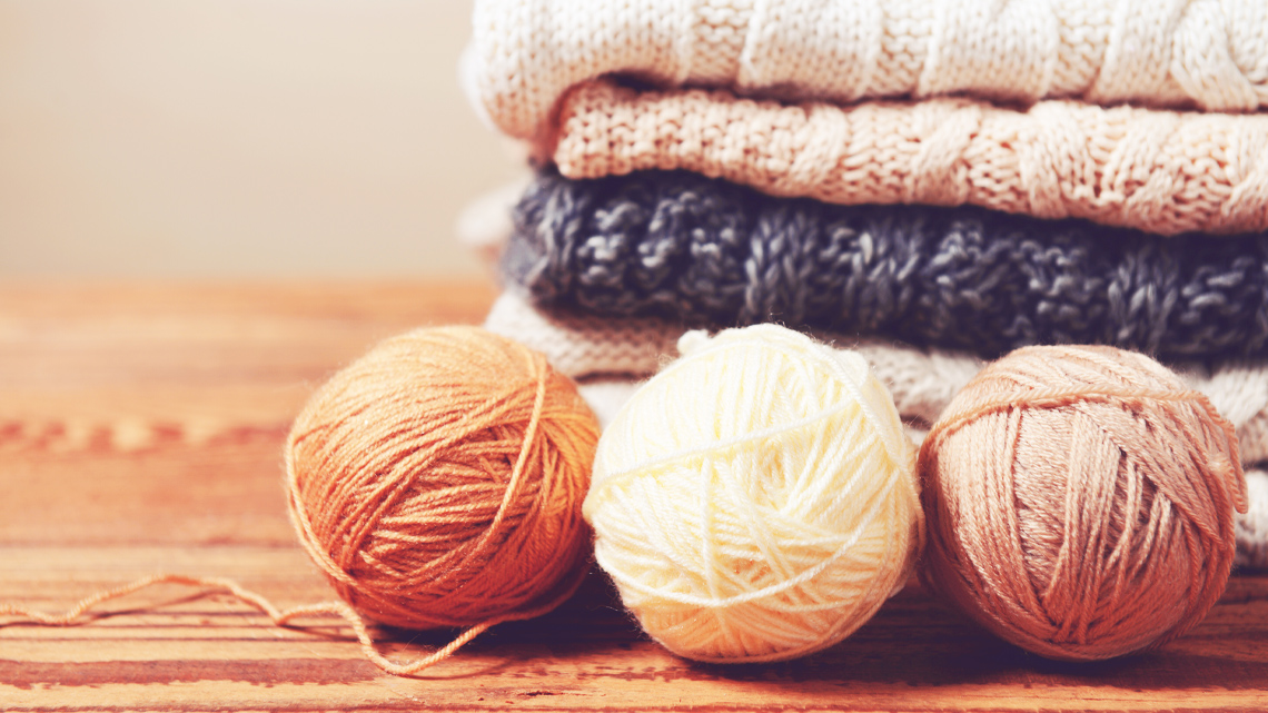 Balls of yarn and knit sweaters.