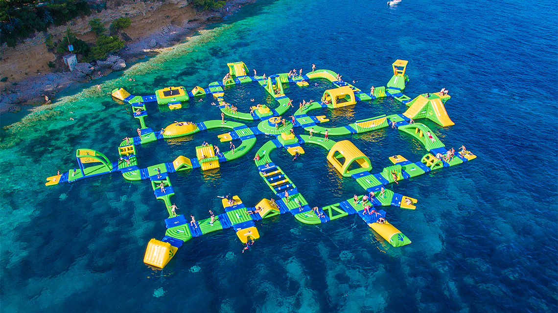 A water playground with floating platforms and play equipment.