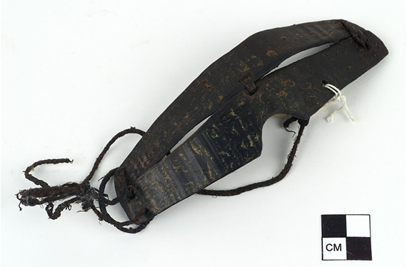 Snow goggles carved from baleen or whalebone and laced using sinew. Narrow slits are created on each side of the goggles.