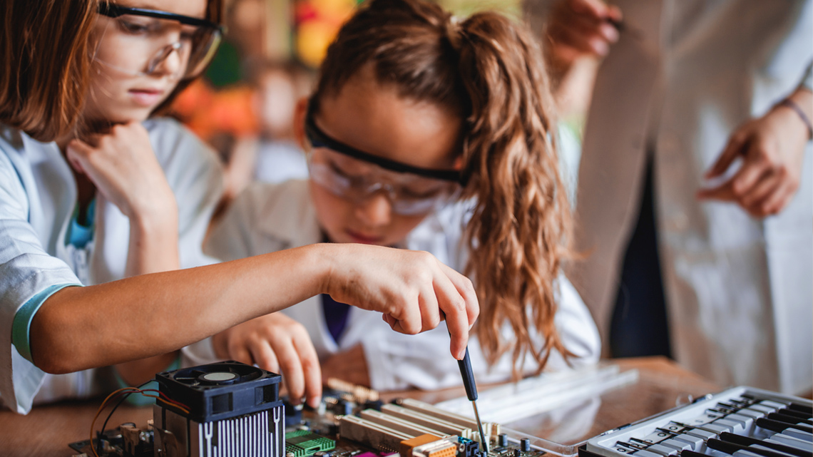 Two young students working on electrical circuits.