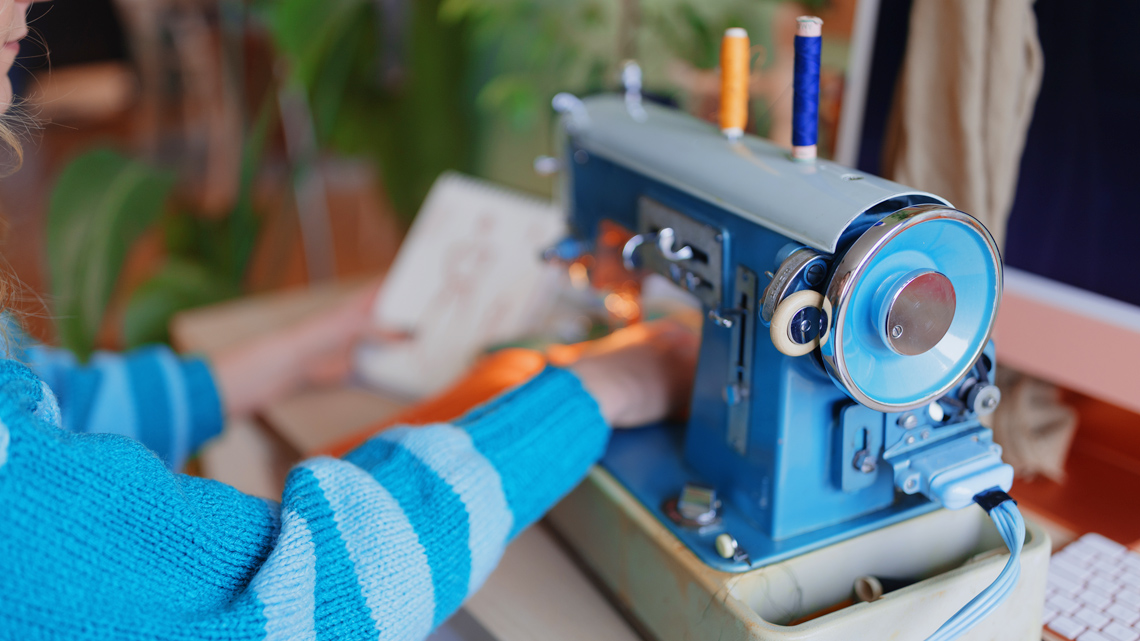 A person using a sewing machine.