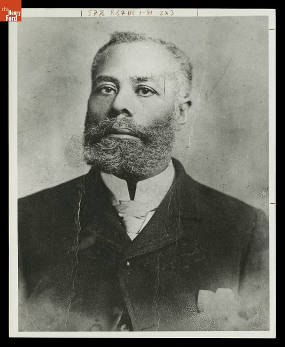 A historical black and white photograph of Elijah McCoy.