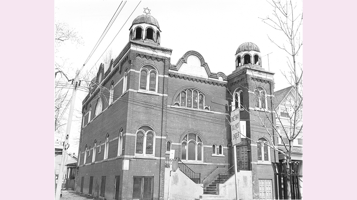A large, elaborate brick building with turrets and arches. Each turret is topped with a star of David.