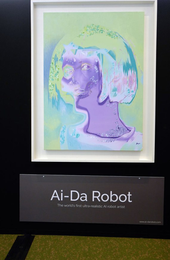 An abstract portrait of a humanoid figure with a short bob haircut labeled "Ai-Da Robot. The world's first ultra-realistic AI robot artist"