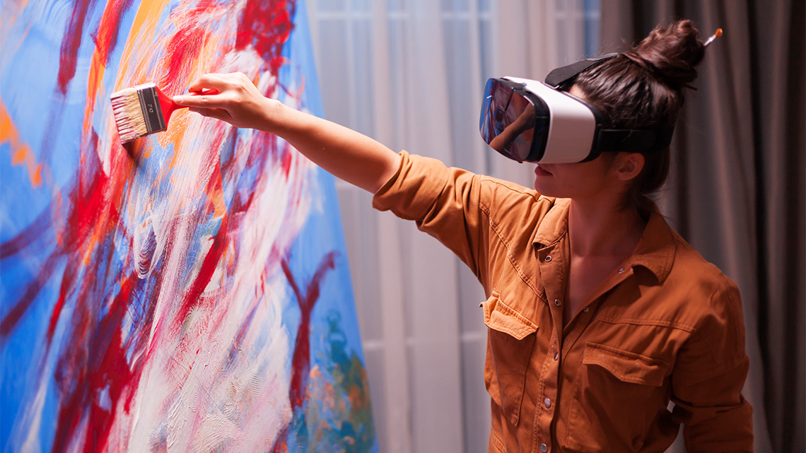 A person painting while wearing an augmented reality headset