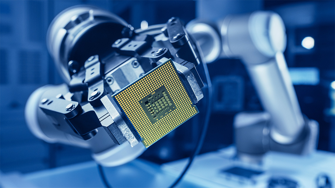 A robotic arm holding a computer processor chip