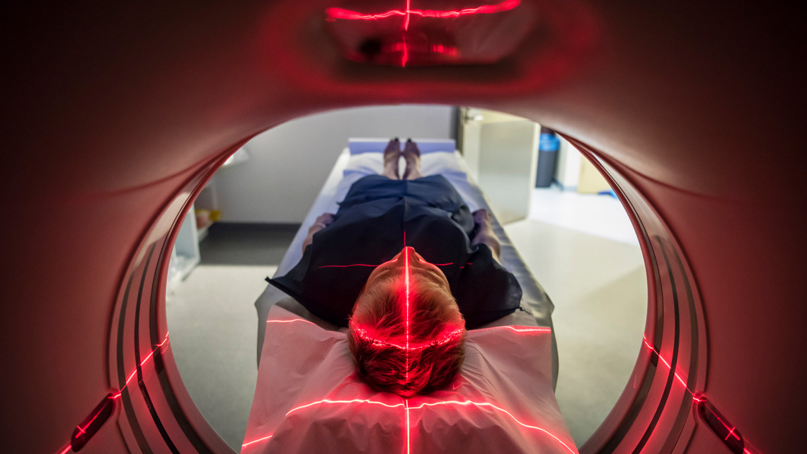 A patient undergoing a CAT scan in a hospital