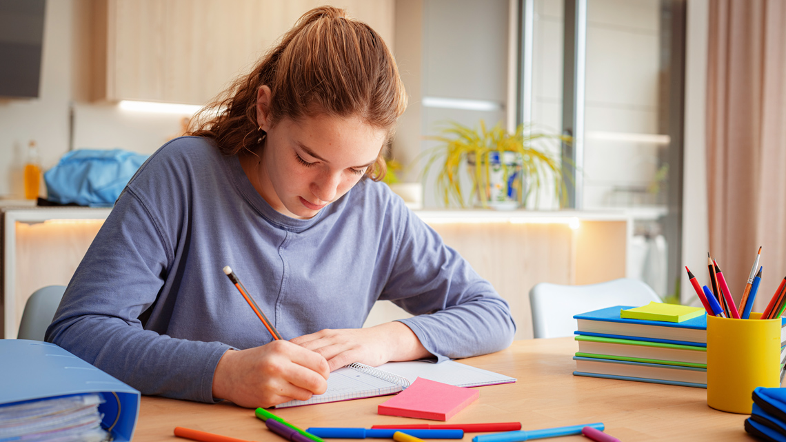 A learner taking notes.