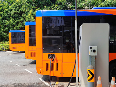 An electric bus being charged.