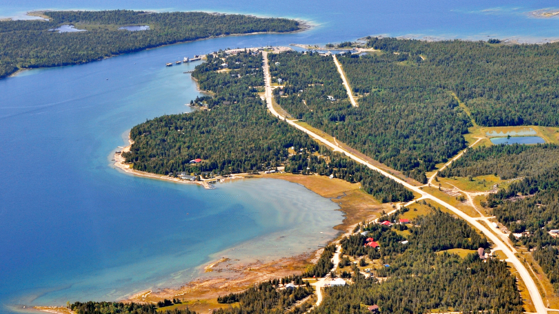 An island covered in forests divided up by roads and paths.