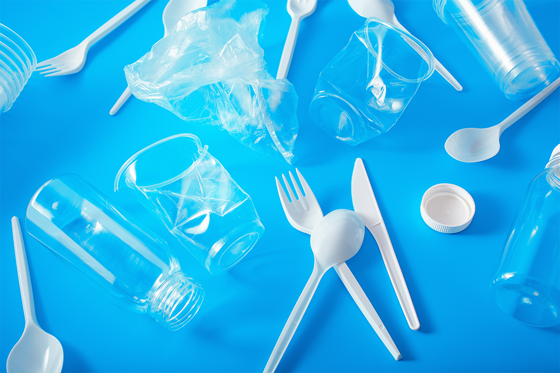 Plastic cutlery, a plastic bag, a plastic bottle cap, plastic cups, and plastic bottles.