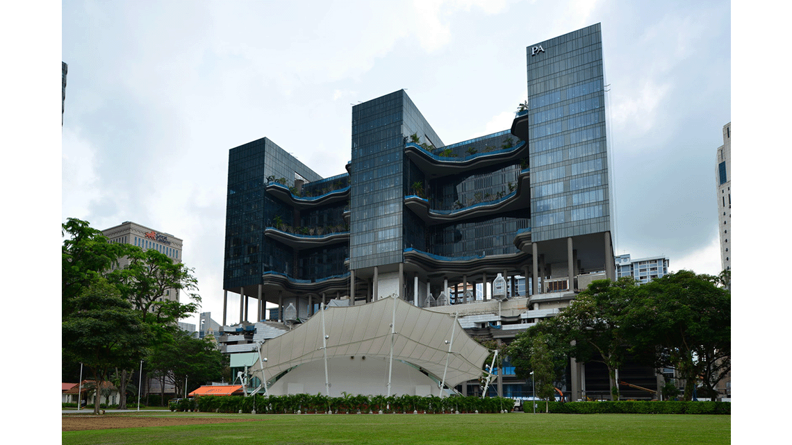 A multi-storey hotel with two middle sections with large balconies.
